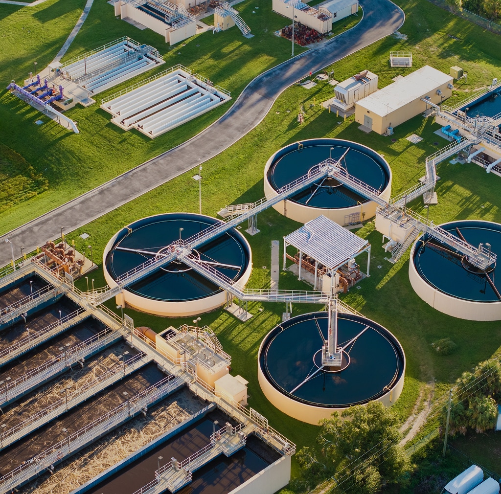 Aerial view of a water treatment plant with circular settling tanks