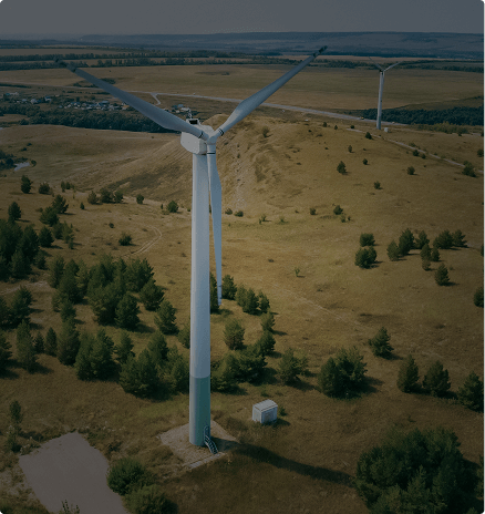 Wind turbines on hills surrounded by farmland — renewable energy